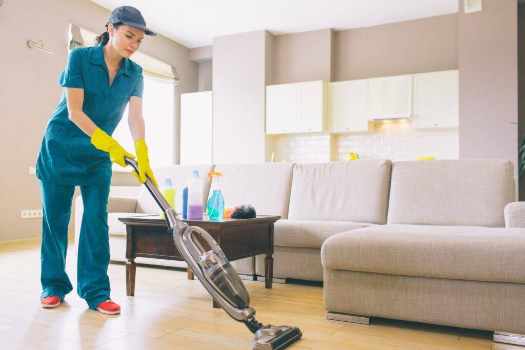 Professional Cleaner cleaning the living room of a home