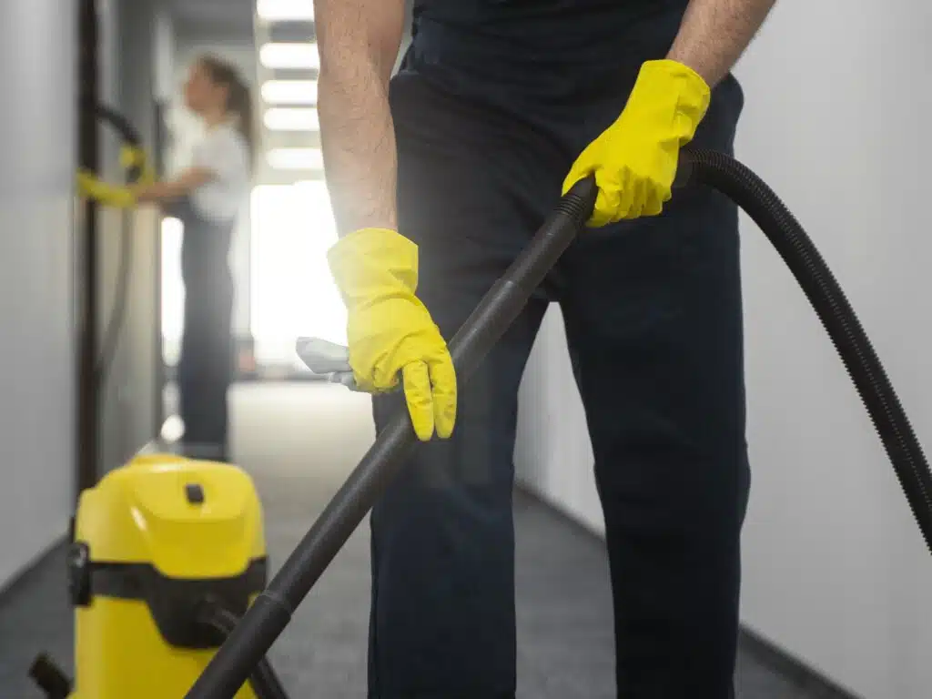 front view man cleaning indoors